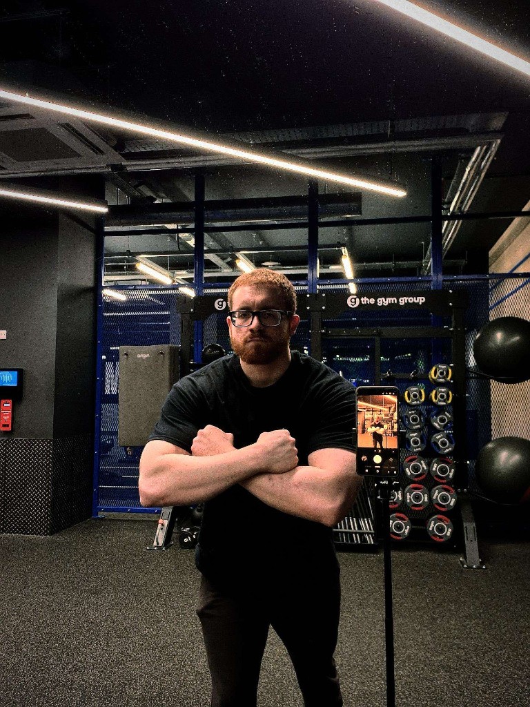 Davide, coach at Paradox Fitness, with his arms crossed at The Gym Group White City.